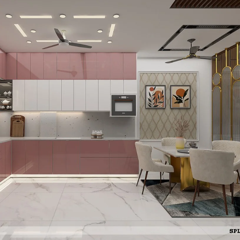 Pink and white modular kitchen with an open dining area featuring a marble-top table and gold legs