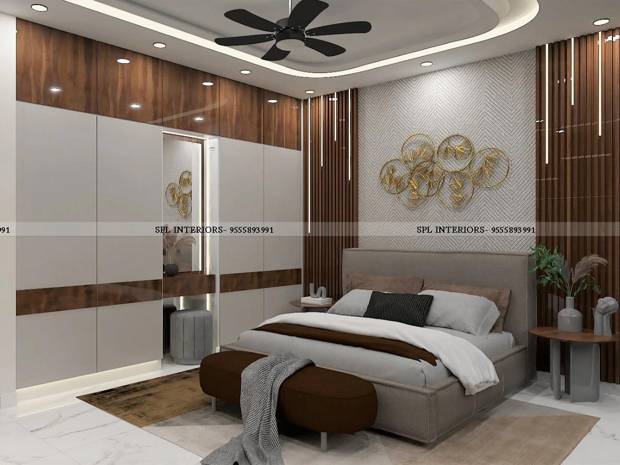 Bedroom with grey bed, herringbone accent wall, and gold circular ring wall art